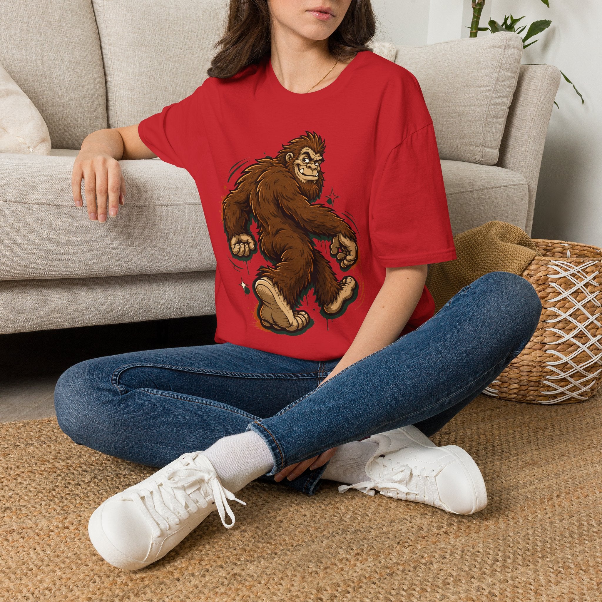 Red crew-neck t-shirt with brown smirking bigfoot cartoon graphic