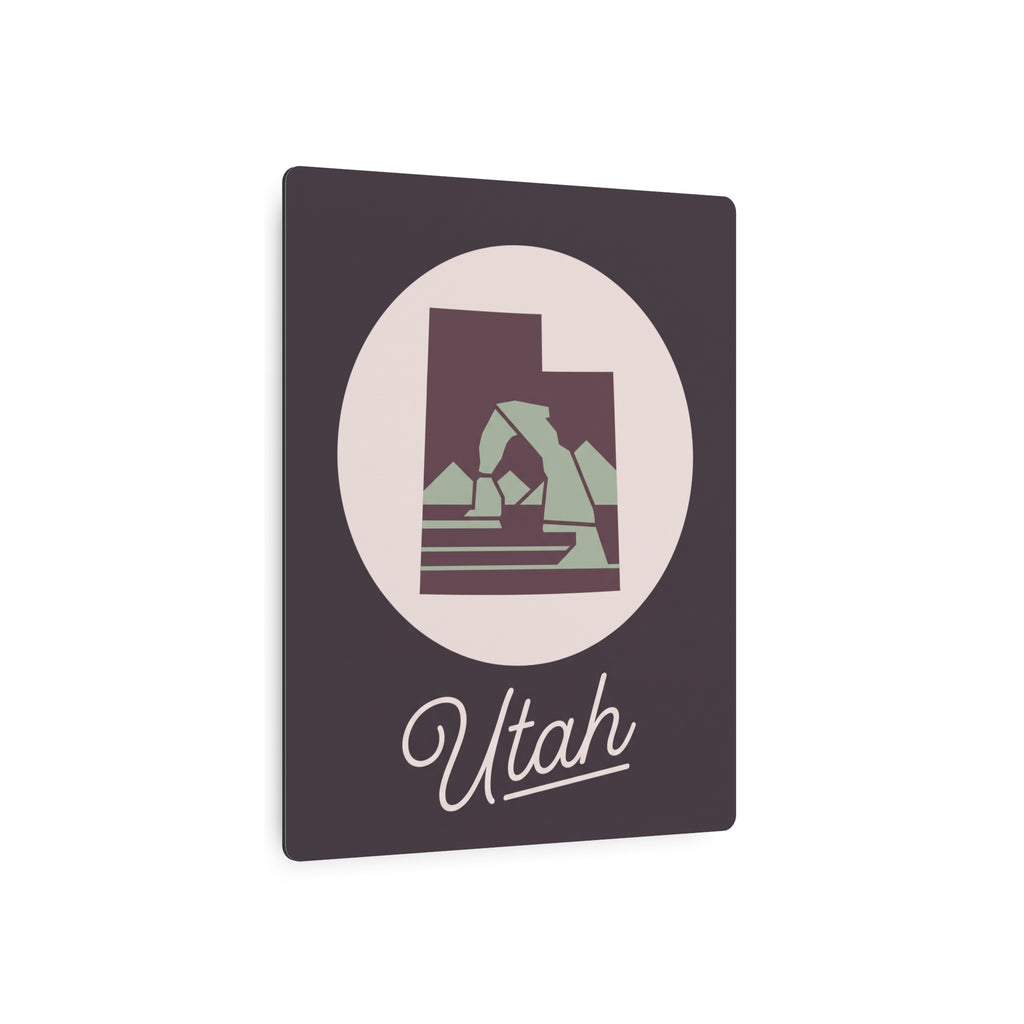 Dark square metal wall plaque with circular Utah emblem and script “Utah”