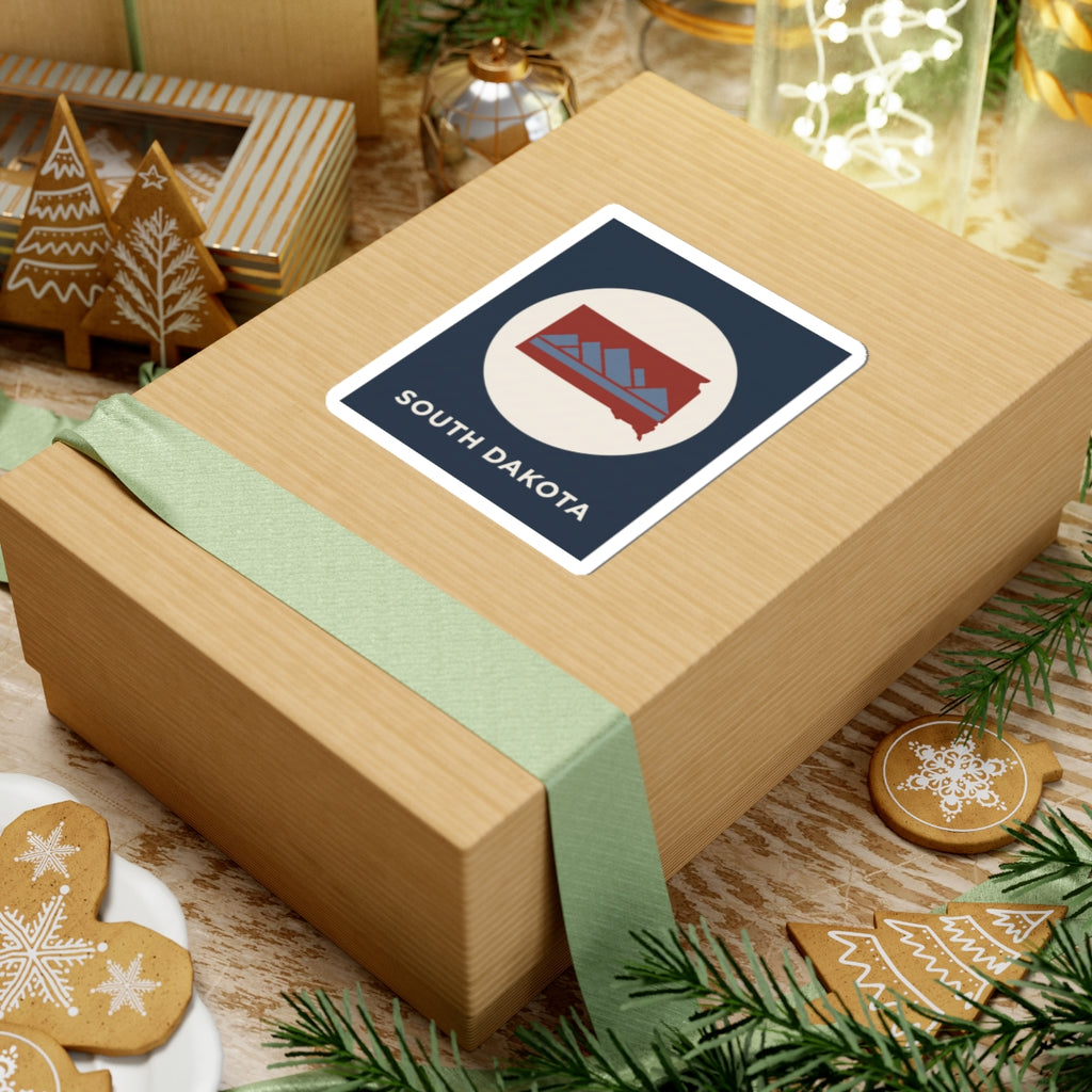 South Dakota map badge sticker on gift wrap, navy square and white circle with red state design