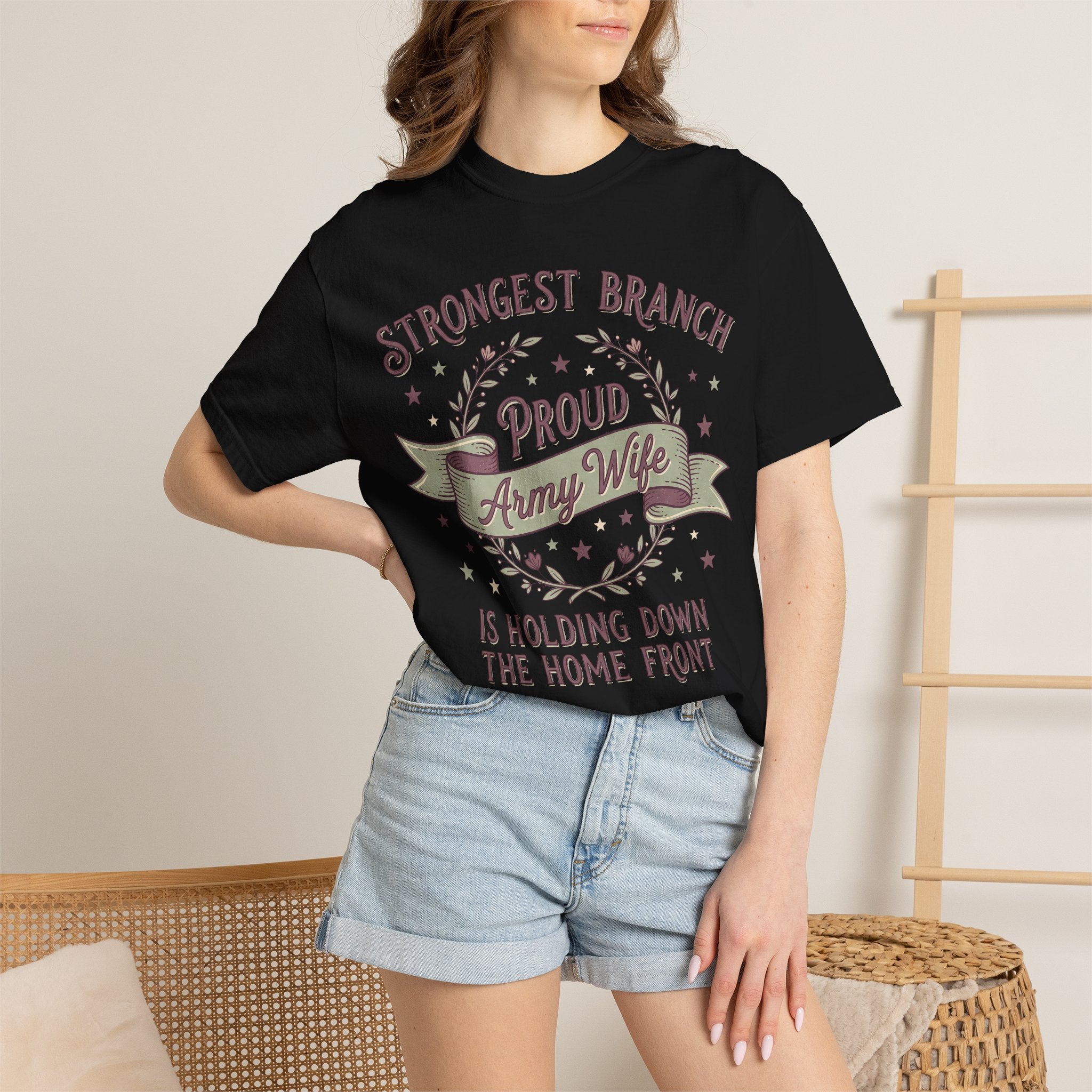Black T-shirt worn by a person, featuring “Proud Army Wife” patriotic text graphic