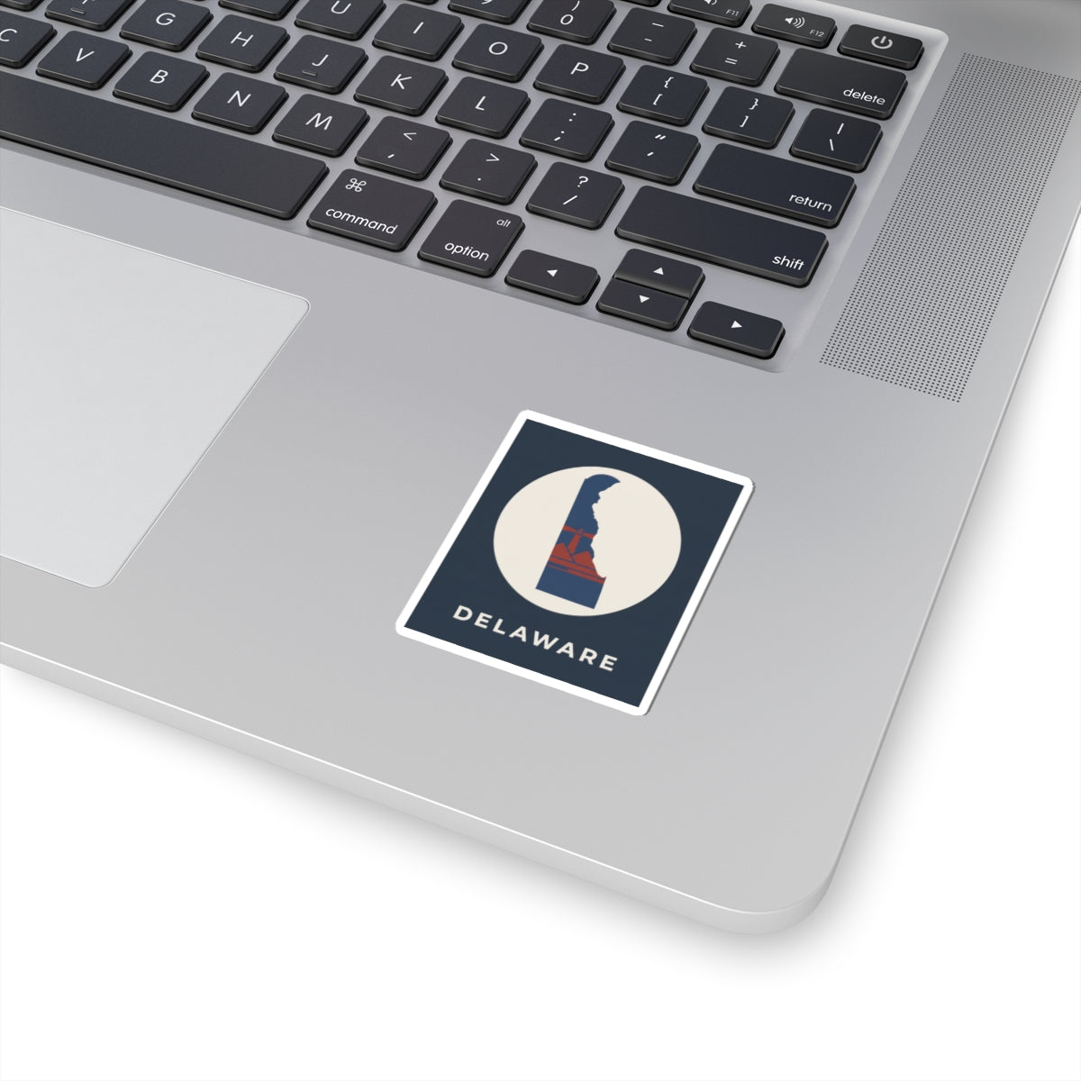 Delaware state silhouette kiss-cut sticker, blue emblem on cream circle