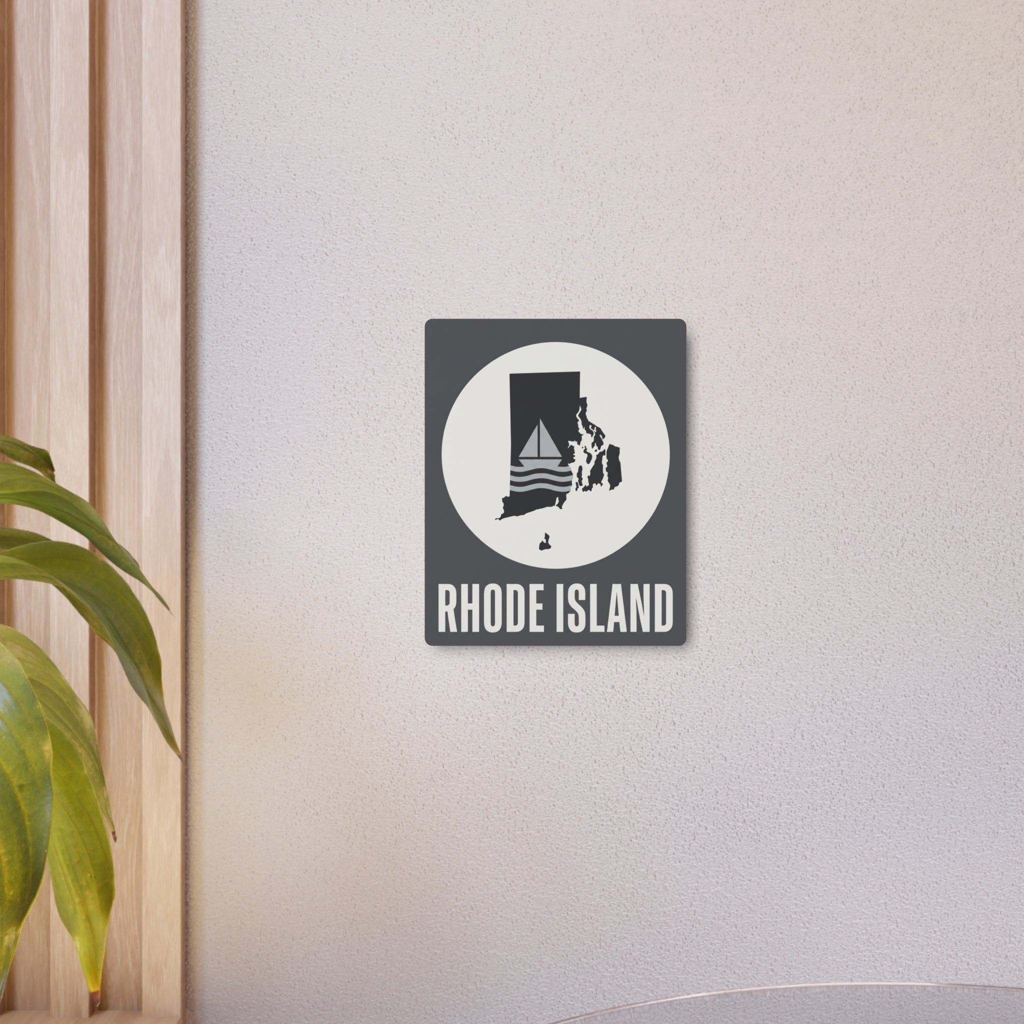 Rhode Island metal art sign: dark square with white circle sailboat silhouette and "RHODE ISLAND"