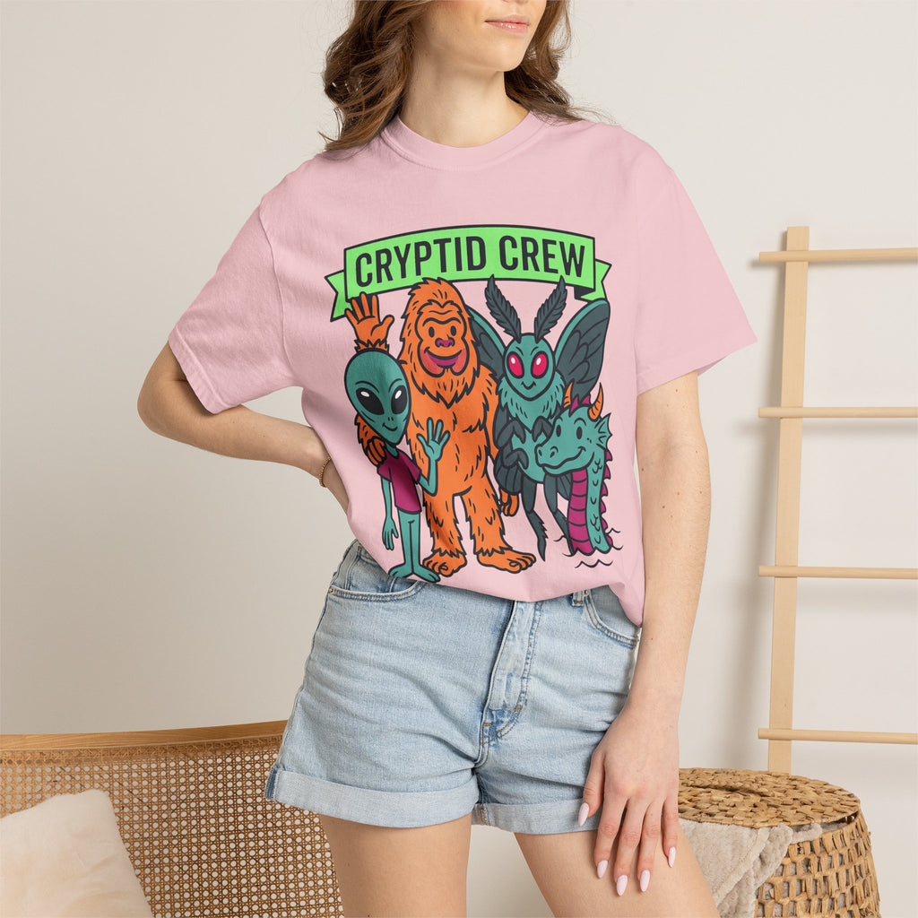 Light pink crew neck t-shirt with multicolor cryptid graphic and green 'CRYPTID CREW' text
