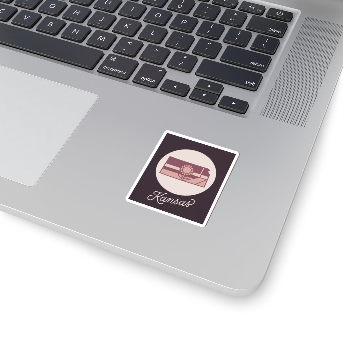 Mauve Kansas state silhouette vinyl sticker with white border and kiss-cut backing