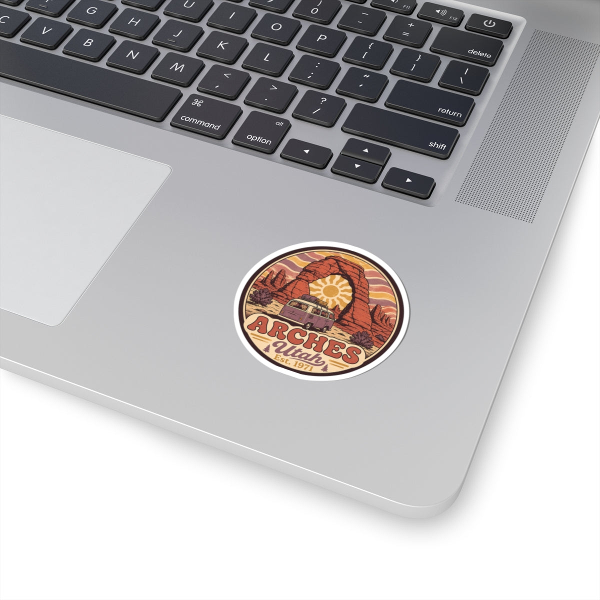 Round Arches National Park sticker with desert arch illustration in red and orange
