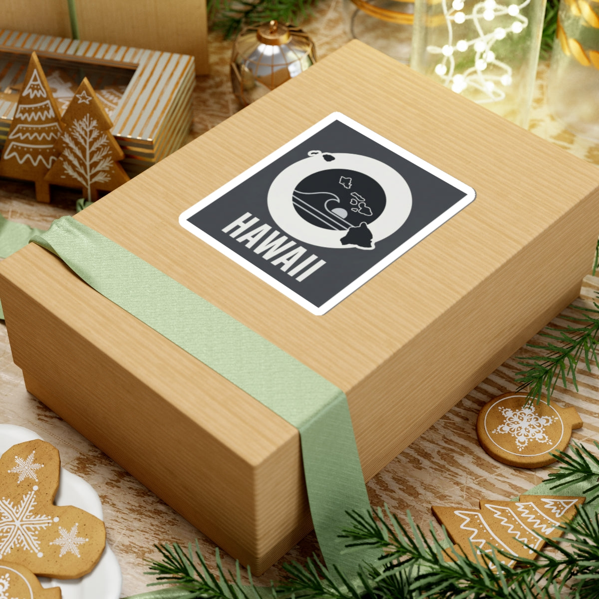 Square kiss-cut sticker on gift wrap, white-bordered black wave emblem with HAWAII text