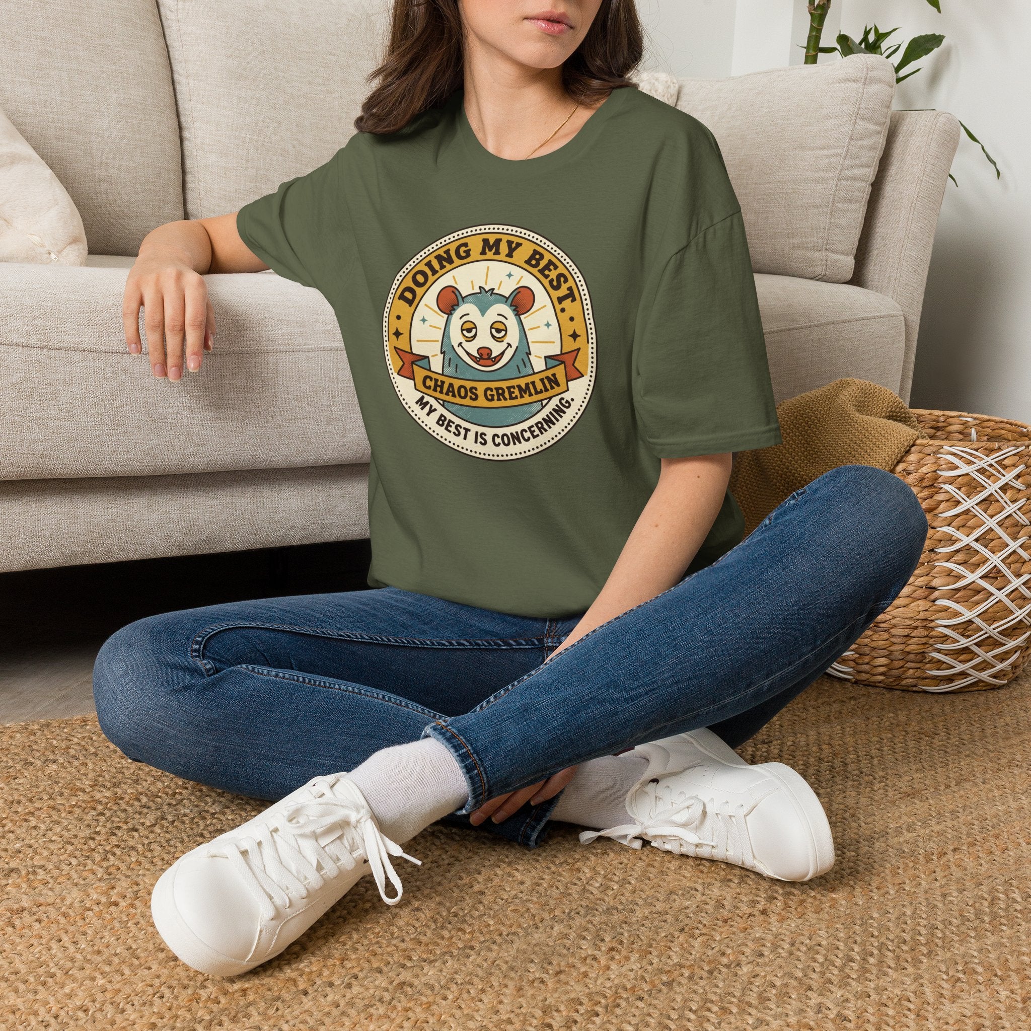 Olive green Chaos Gremlin graphic T-shirt with circular mascot logo on chest