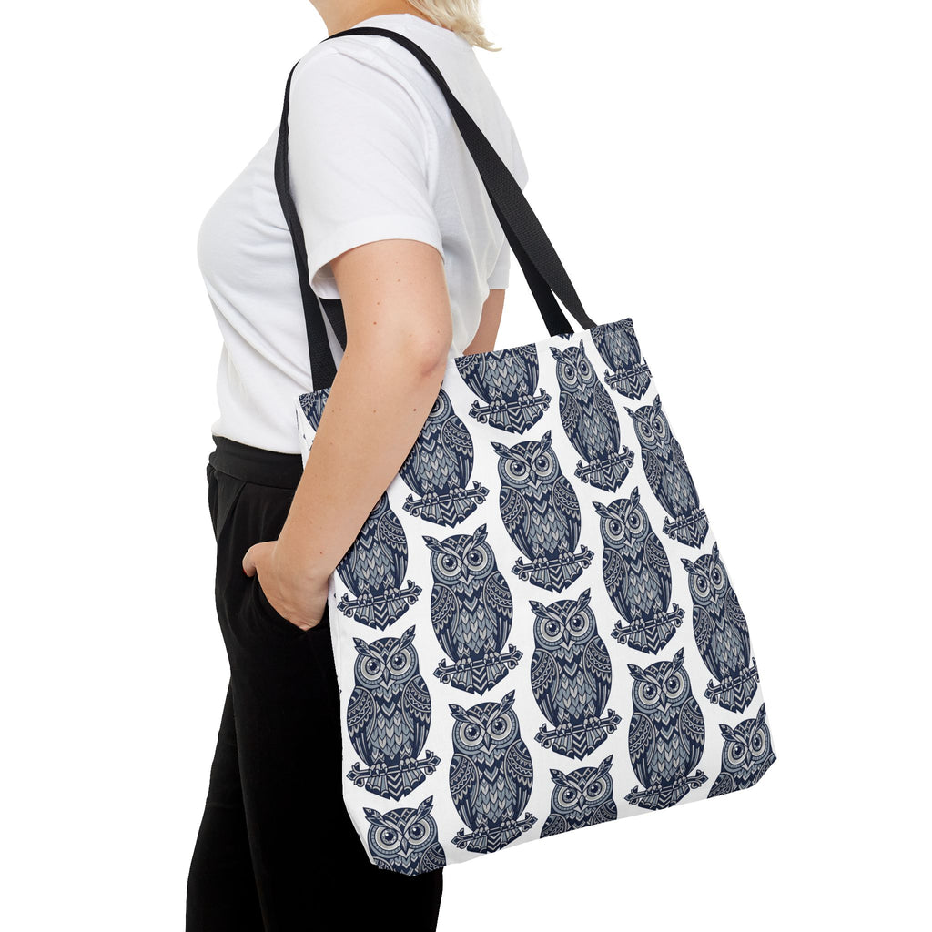Owl print tote bag with black handles, worn on shoulder; repeating blue and white owls.
