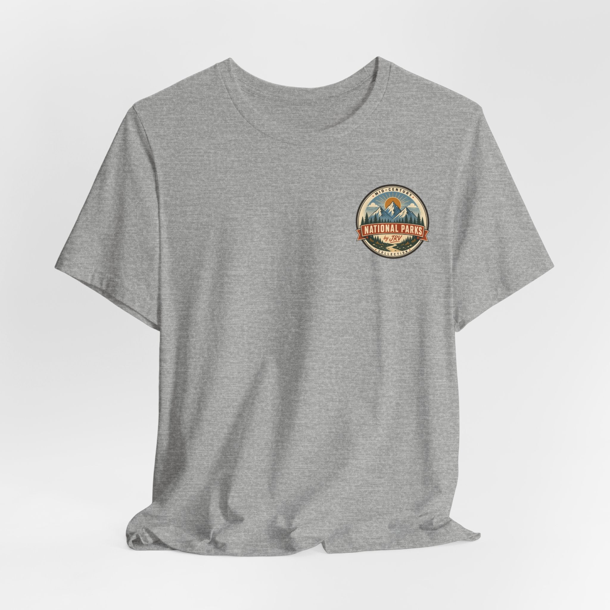 Heather gray t-shirt on model, small round National Park patch logo at the chest.