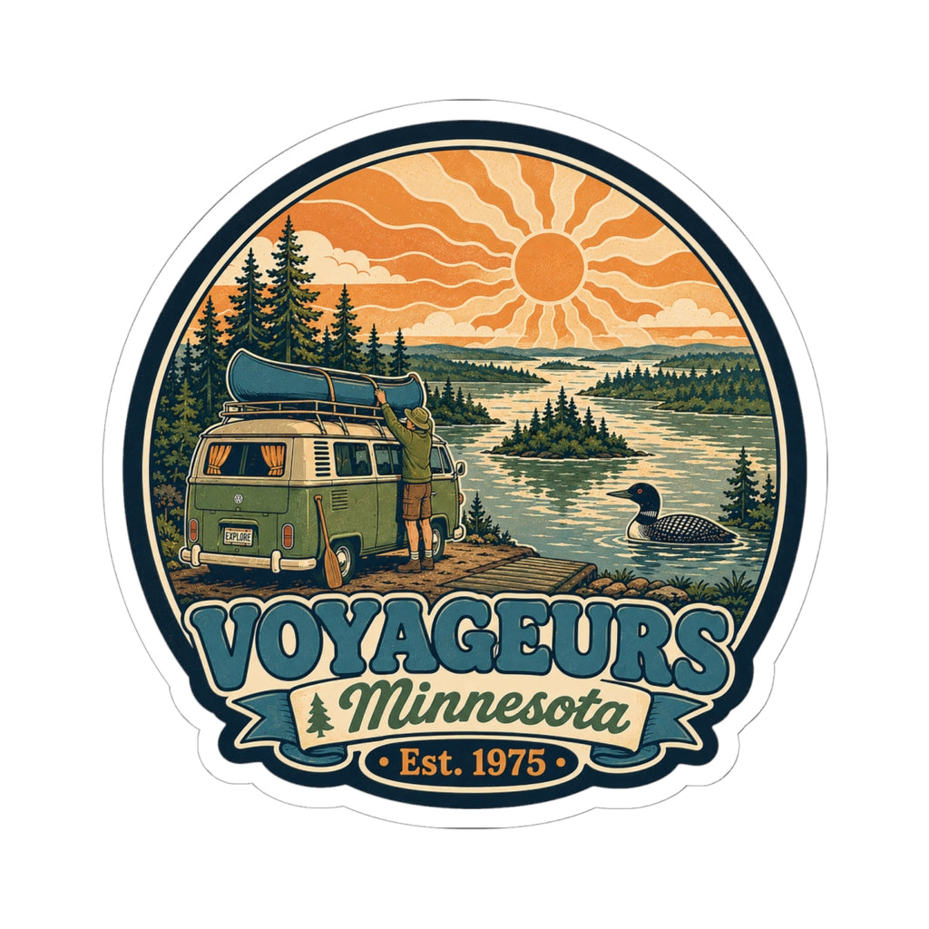 Round die-cut sticker featuring green camper van, pine trees, lake and orange sun; Voyageurs Minnesota