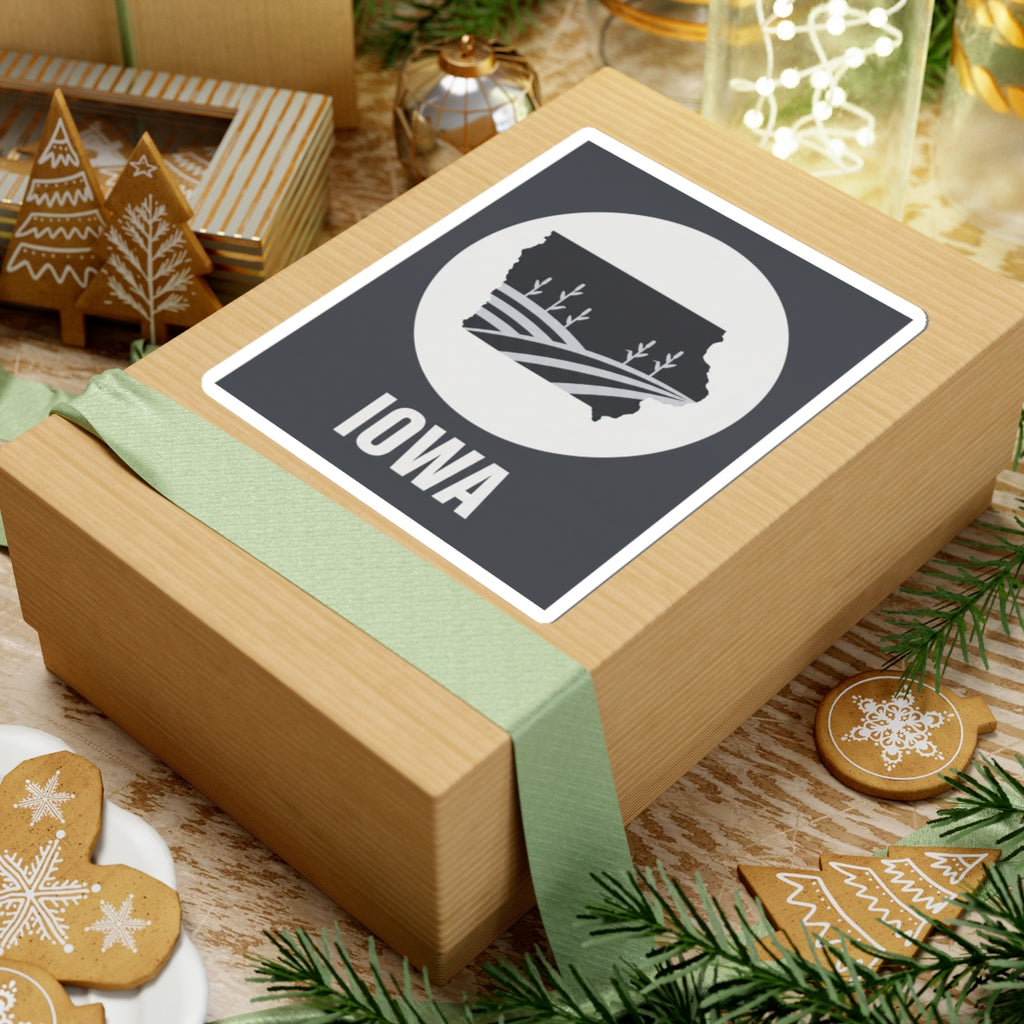 Iowa farmland graphic sticker on a wrapped present: black square with white circle emblem, “IOWA”