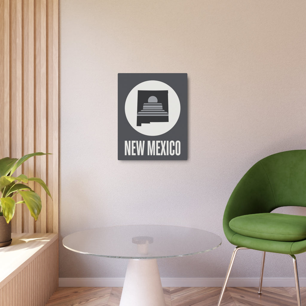 Square metal wall art sign mounted indoors, showing circular skyline icon and “NEW MEXICO”