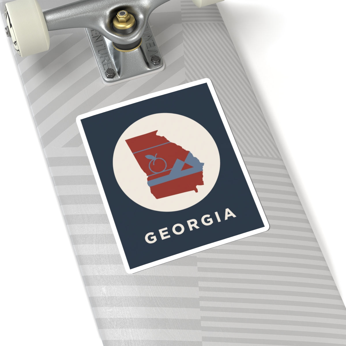 Georgia outline sticker on notebook: circular badge with red state, peach icon, mountains, “GEORGIA”