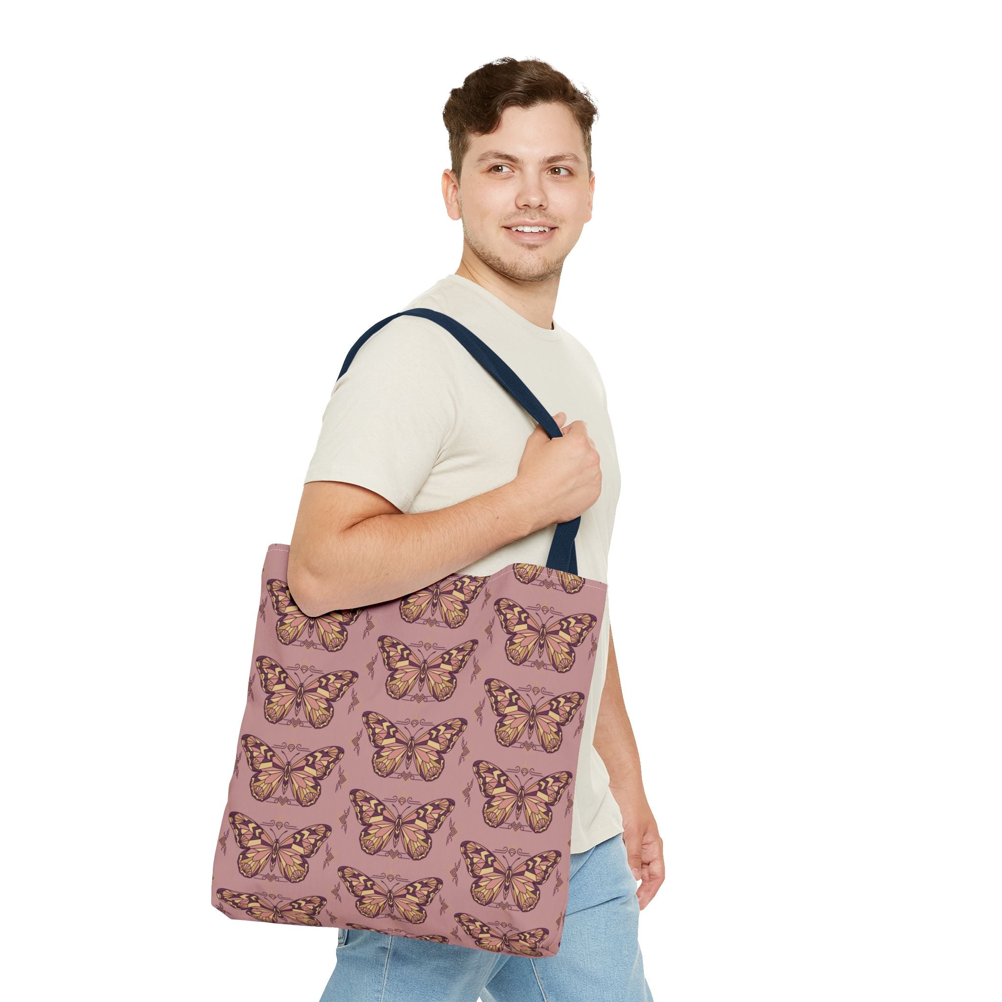 Butterfly print tote bag with dark handle straps, carried on shoulder