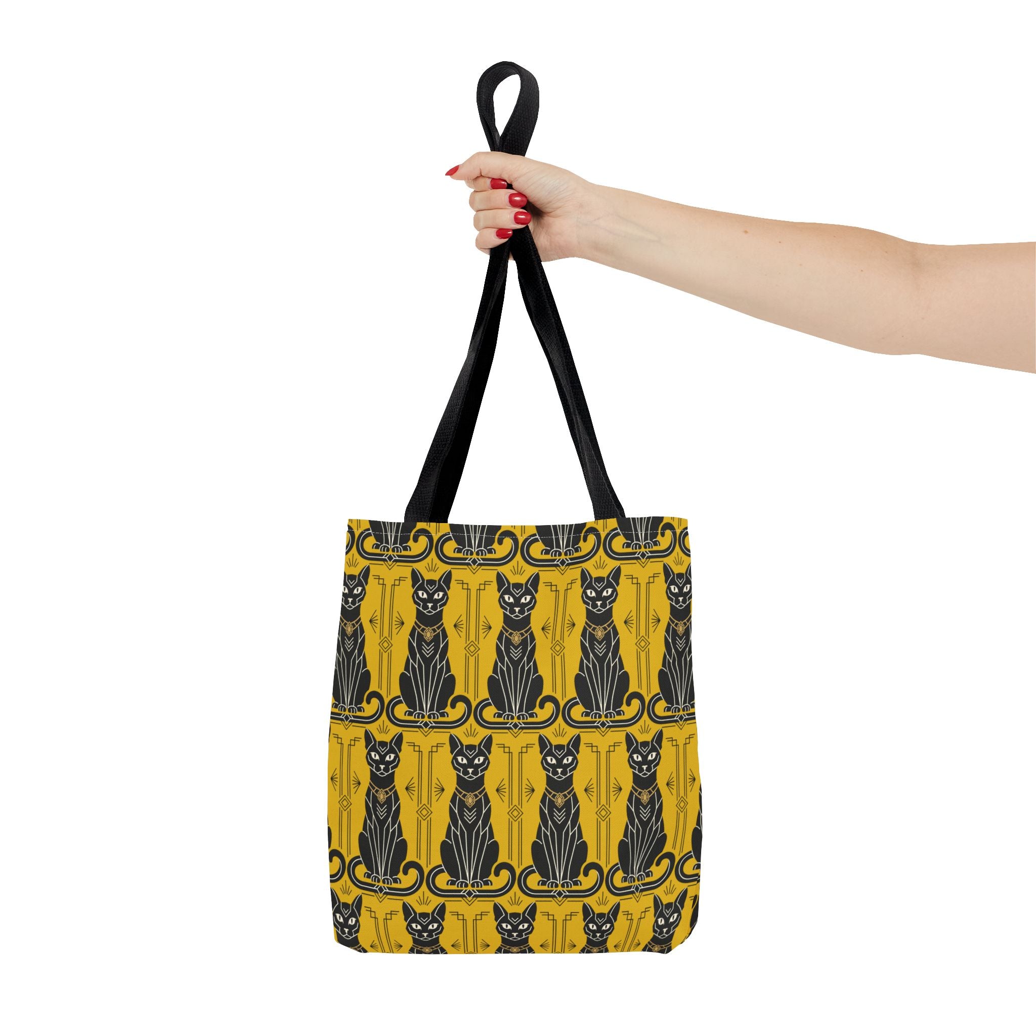 Yellow tote bag with repeating black cat print and ornate border; black top handles