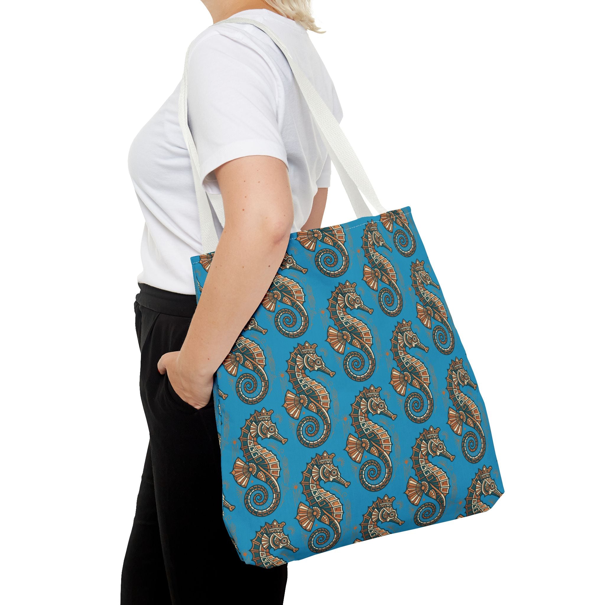 Blue patterned tote bag with beige shoulder straps, shown from the side