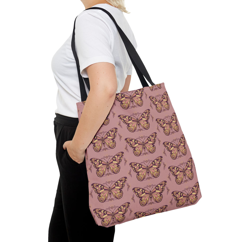 Pink vintage butterfly tote bag with black shoulder straps on model