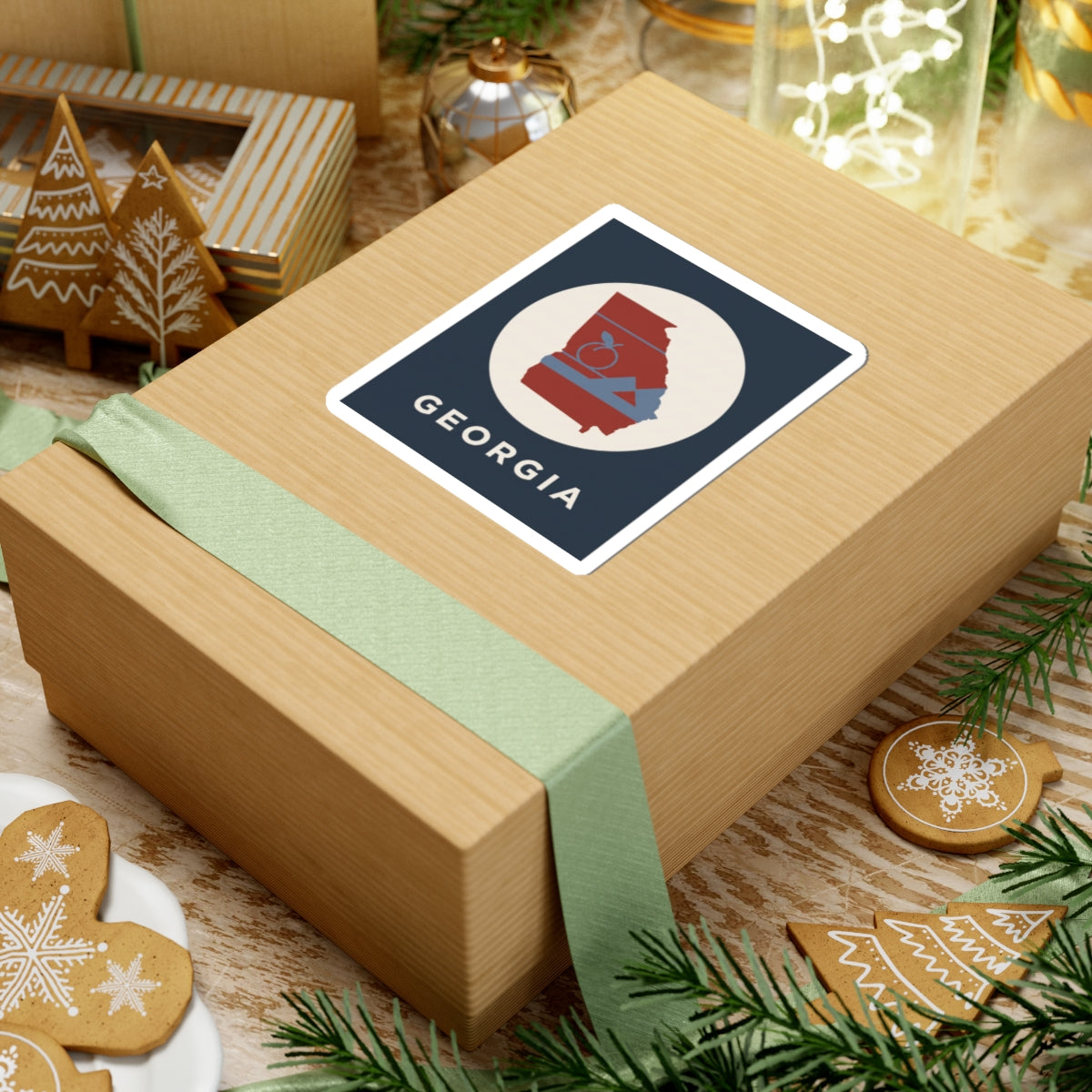 Georgia outline sticker on wrapped present: circular red state with peach icon and mountains, “GEORGIA”