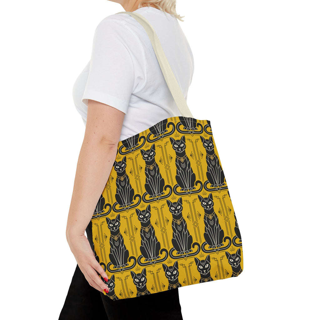 Yellow cat-pattern tote bag worn on shoulder, navy cats and decorative linework