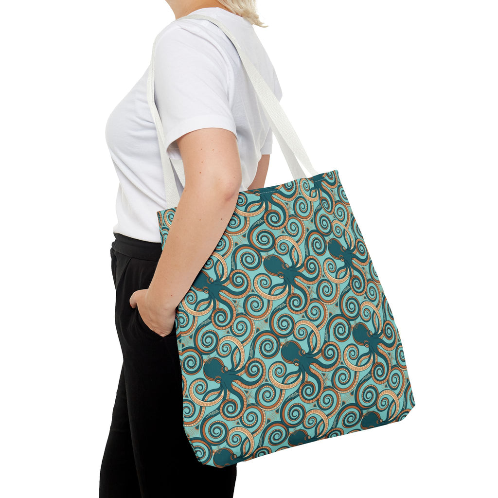 Teal octopus swirl tote bag shown from side with rope handles.