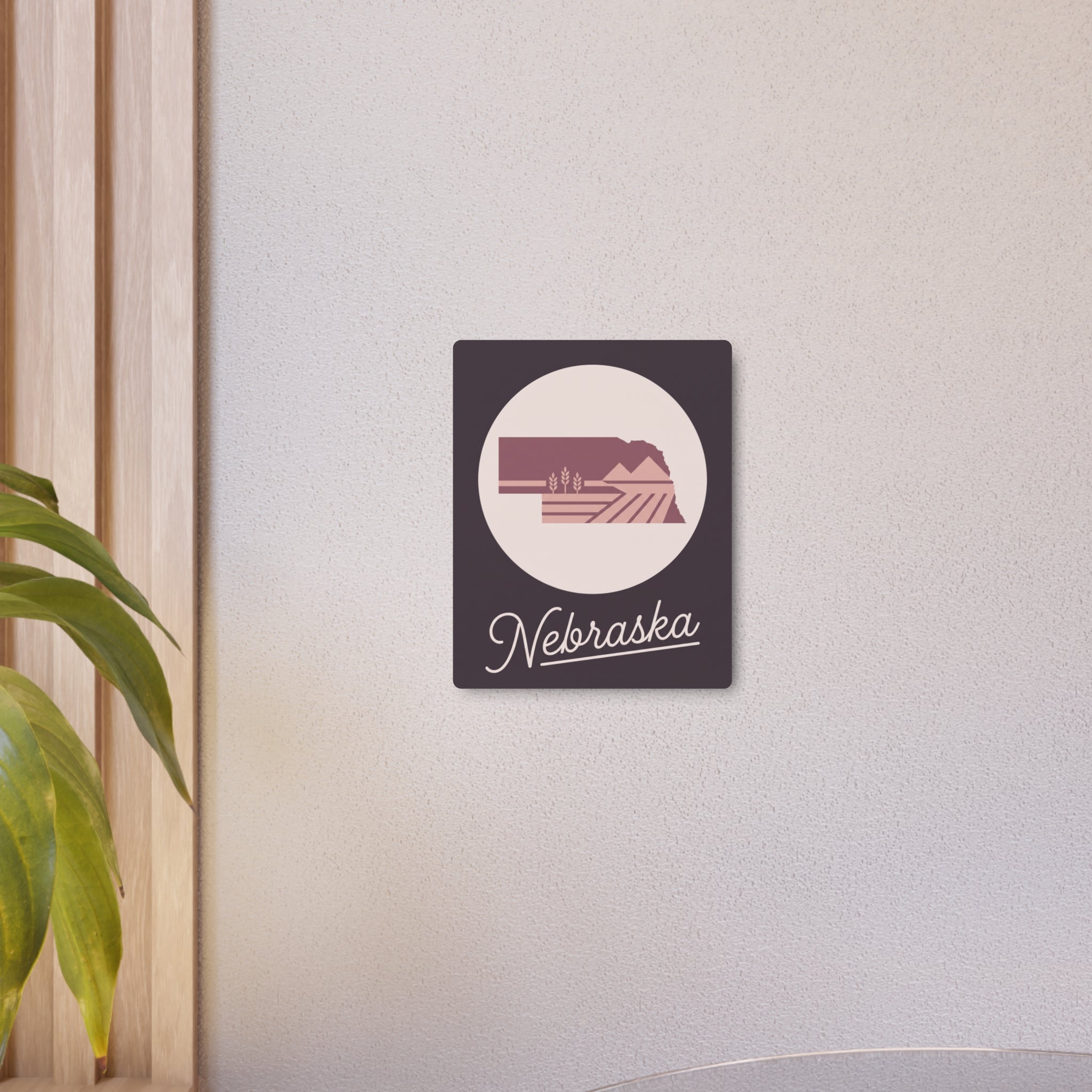 Nebraska metal wall sign with circular landscape logo and 'Nebraska' cursive