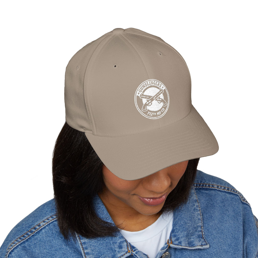 Embroidered khaki baseball cap with round white emblem on front
