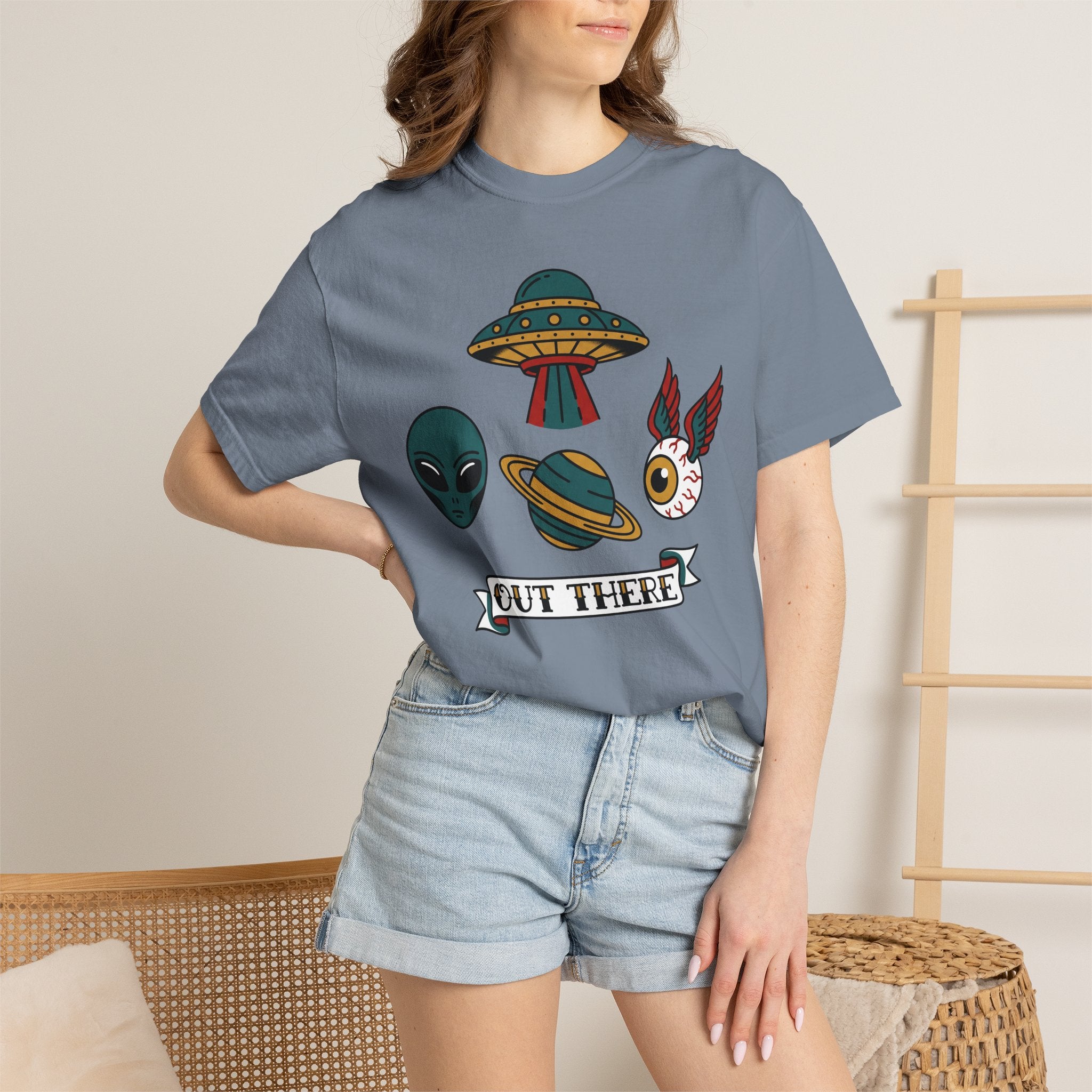 Blue T-shirt on model with alien, UFO and space-cat graphic and OUT THERE label