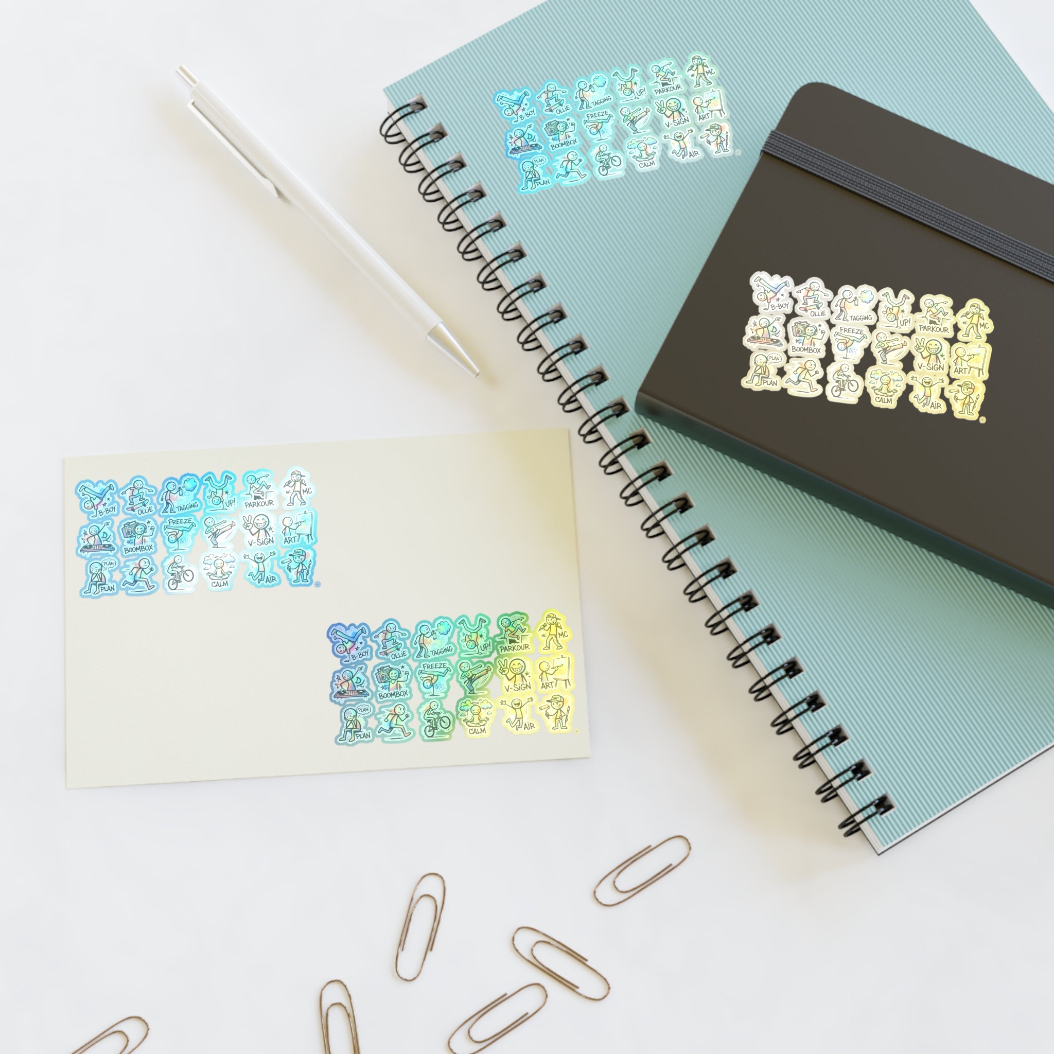 Die-cut character activity stickers on a sheet, shown with notebook and scattered pins