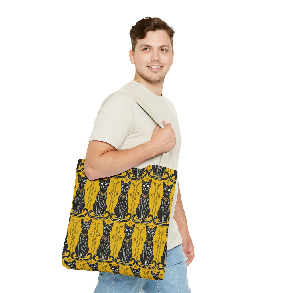 Yellow cat-pattern tote bag worn across body with navy handle straps and cat print
