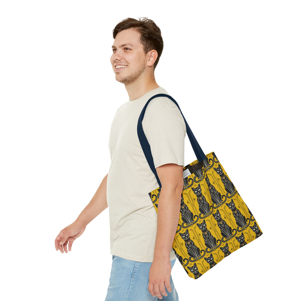 Yellow tote bag with black cat motif, carried over shoulder with navy strap