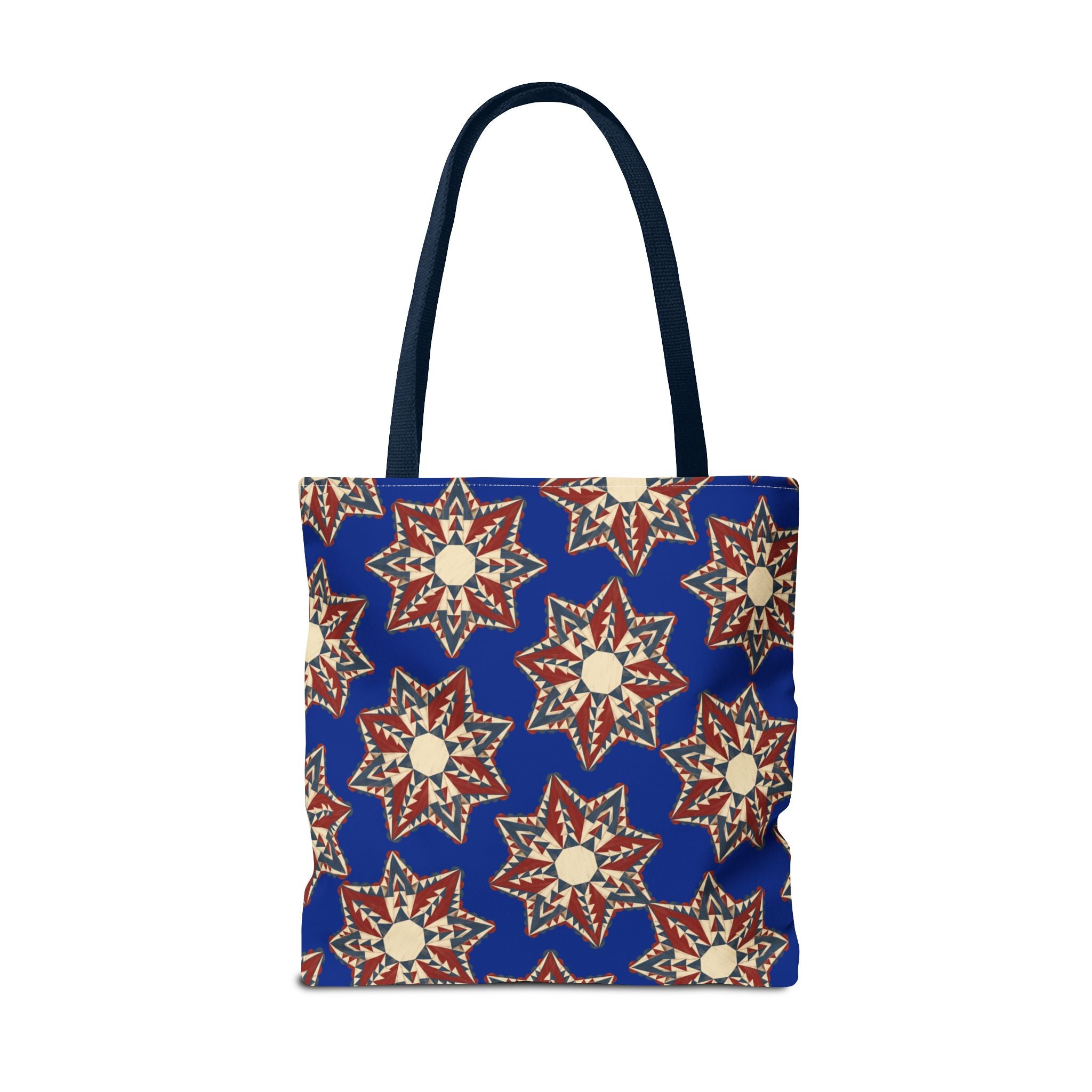 Blue tote bag with red and cream starburst floral pattern, standing front view with handles.