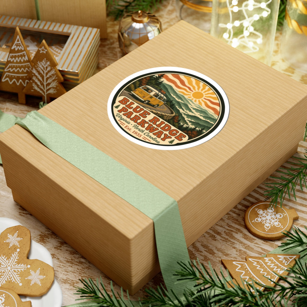 Round Blue Ridge Parkway sticker on gift box with yellow camper van, hills, sun rays and text
