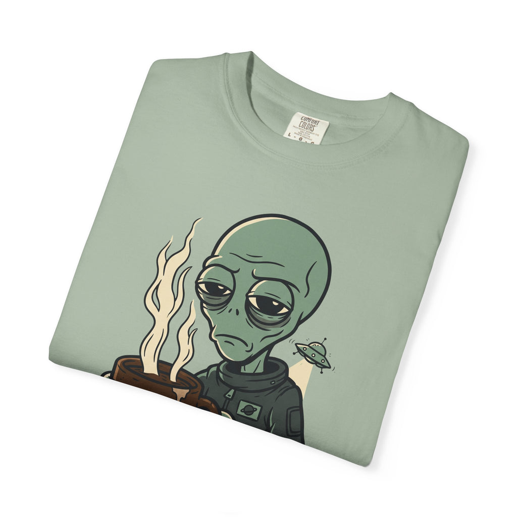 Sage green crew-neck T-shirt with alien holding coffee and small spaceship graphic.