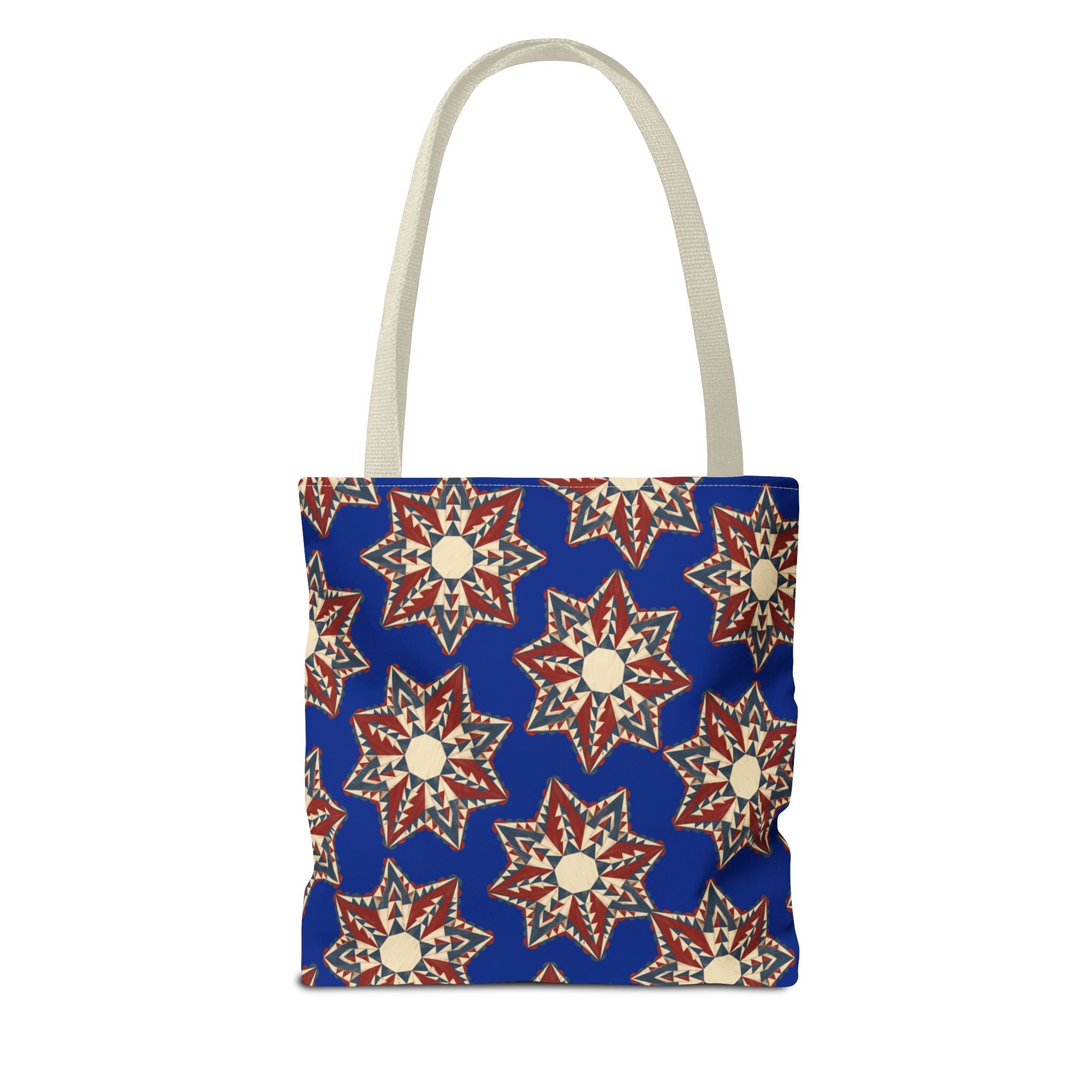 Square blue tote bag with starburst floral design in cream and red, long light handles