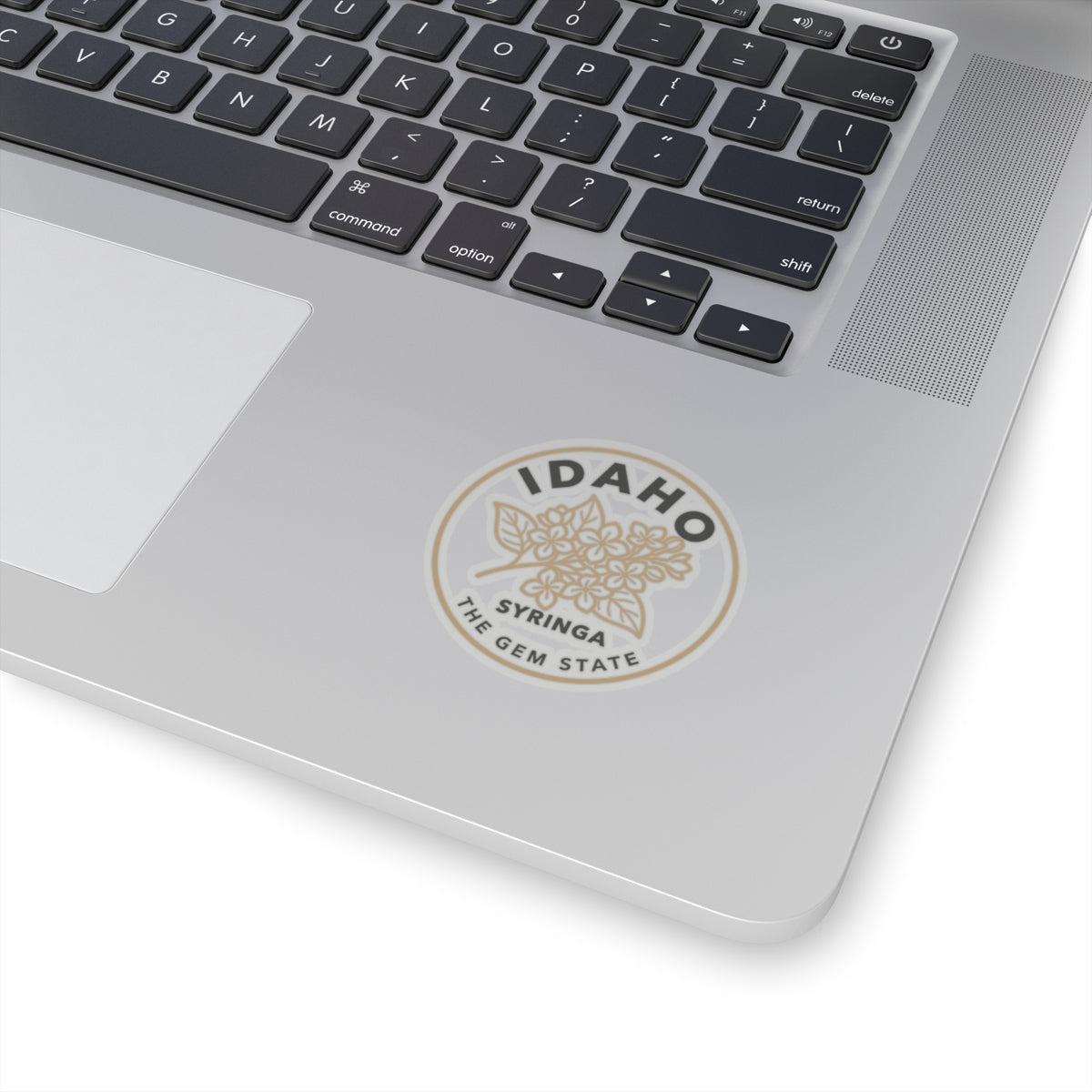 Transparent vinyl sticker on a laptop: circular Idaho syringa flower emblem