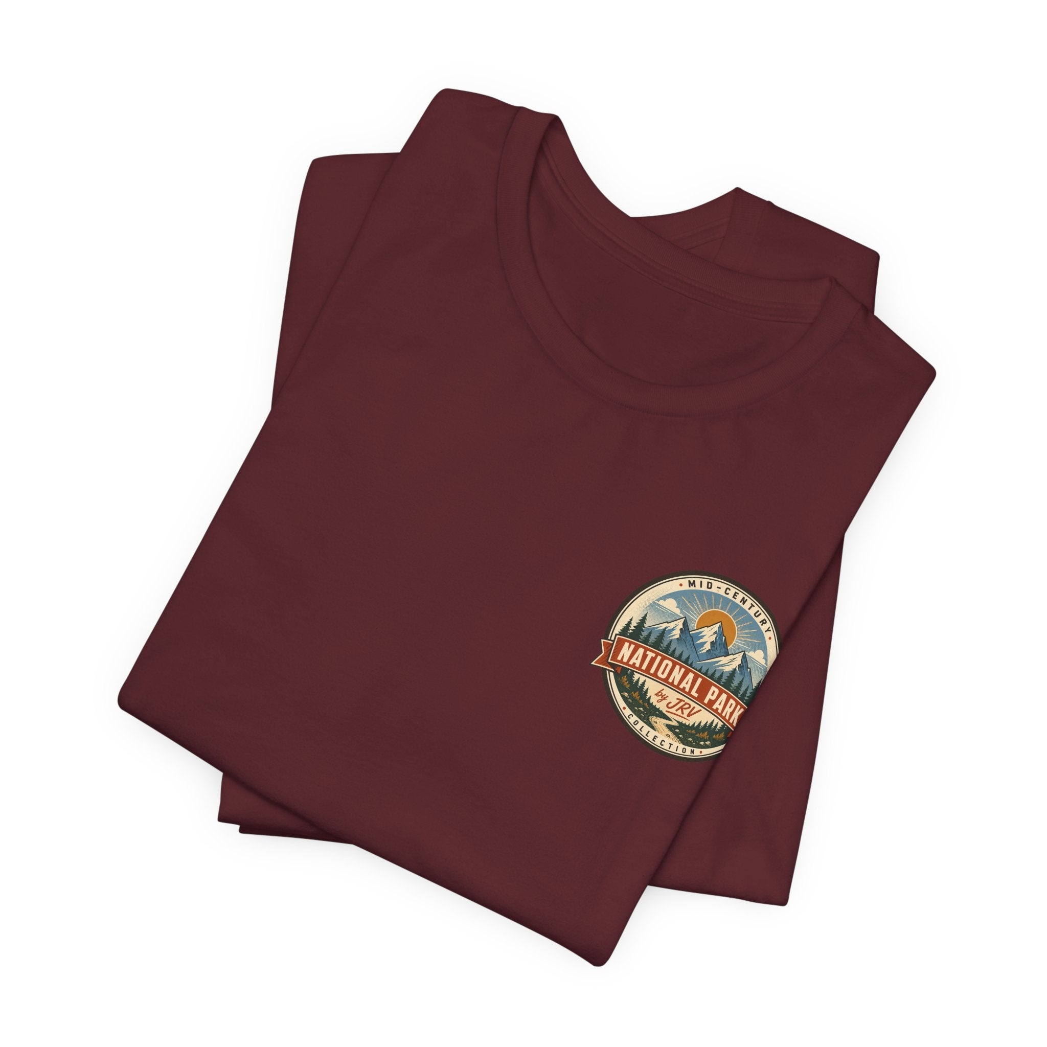 Maroon t-shirt stack with small round National Park badge on chest