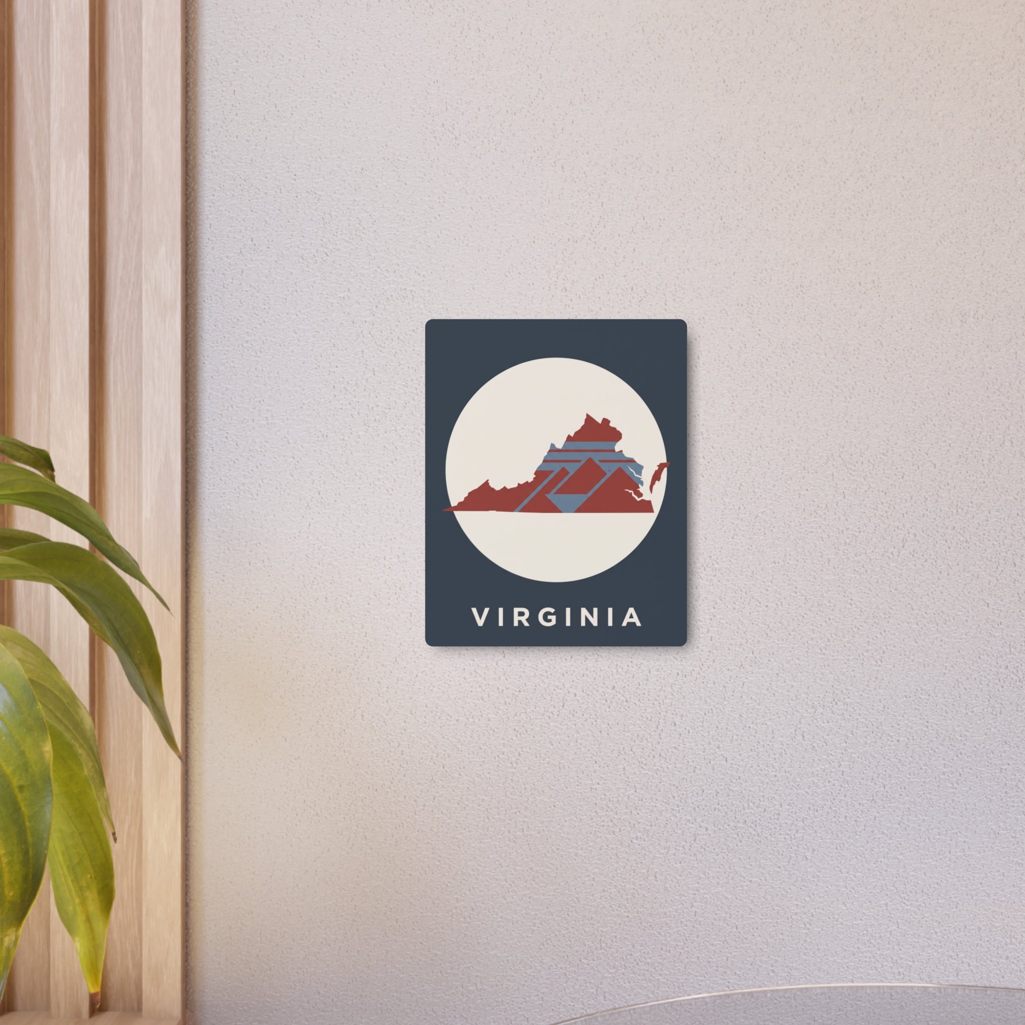 Small Virginia metal sign on wall: dark blue square with circular map and “VIRGINIA”